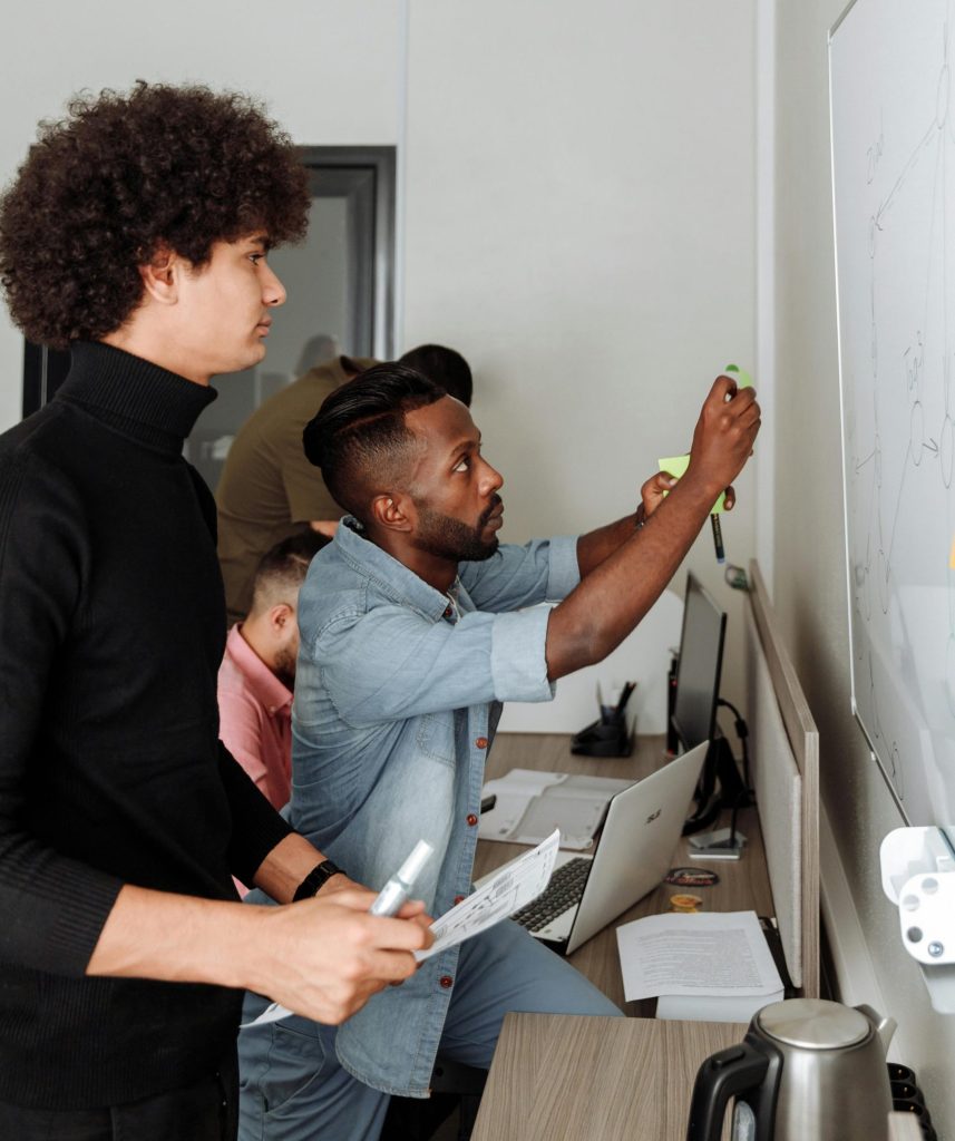 A diverse team working together on a project in a modern office setting, showcasing teamwork and innovation.